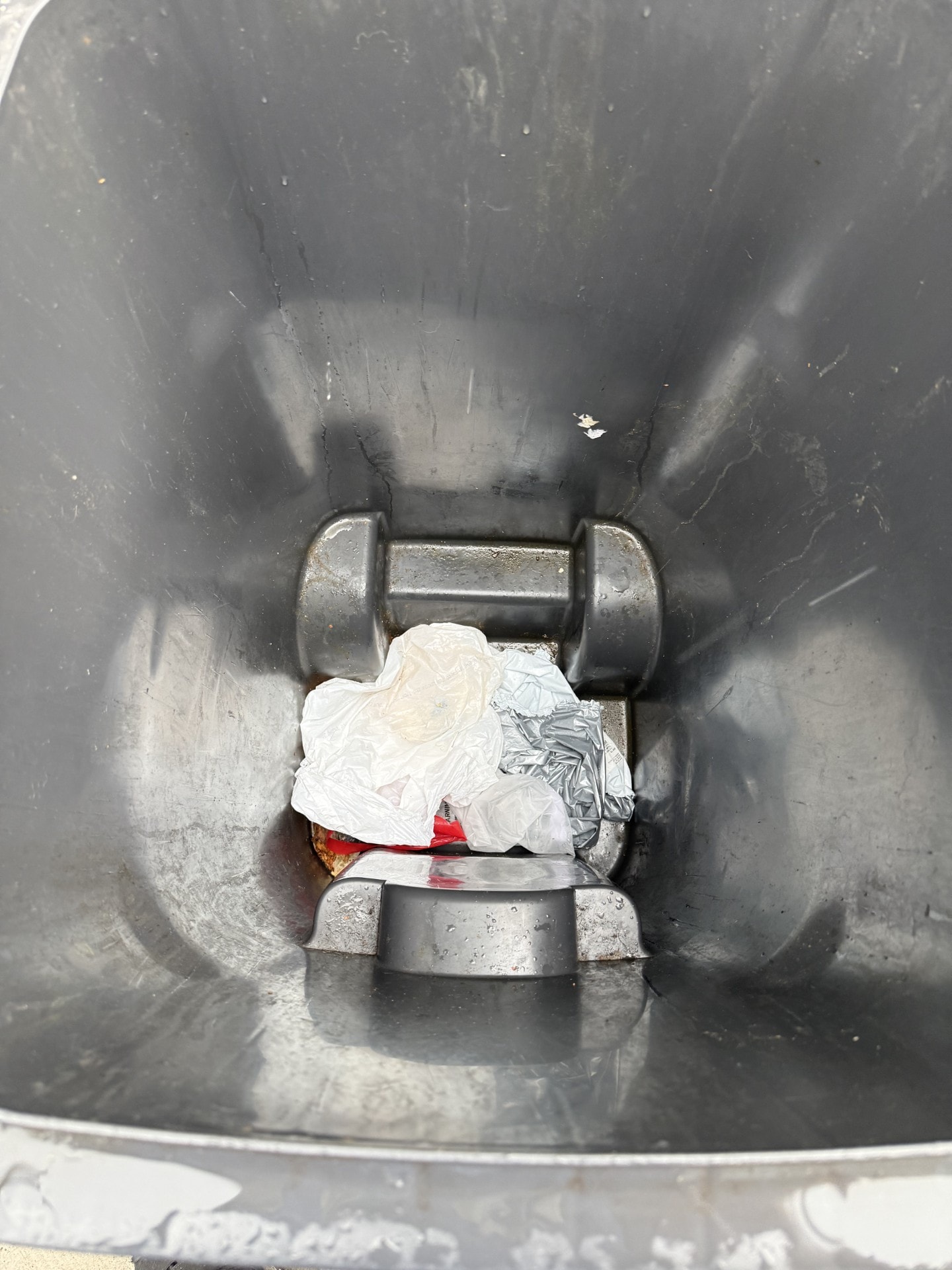 Garbage can before cleaning — dirty interior with debris